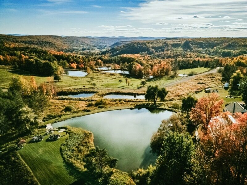 Aerial view of Twelve Ponds in autumn, with ponds set among fall foliage and rolling hills.