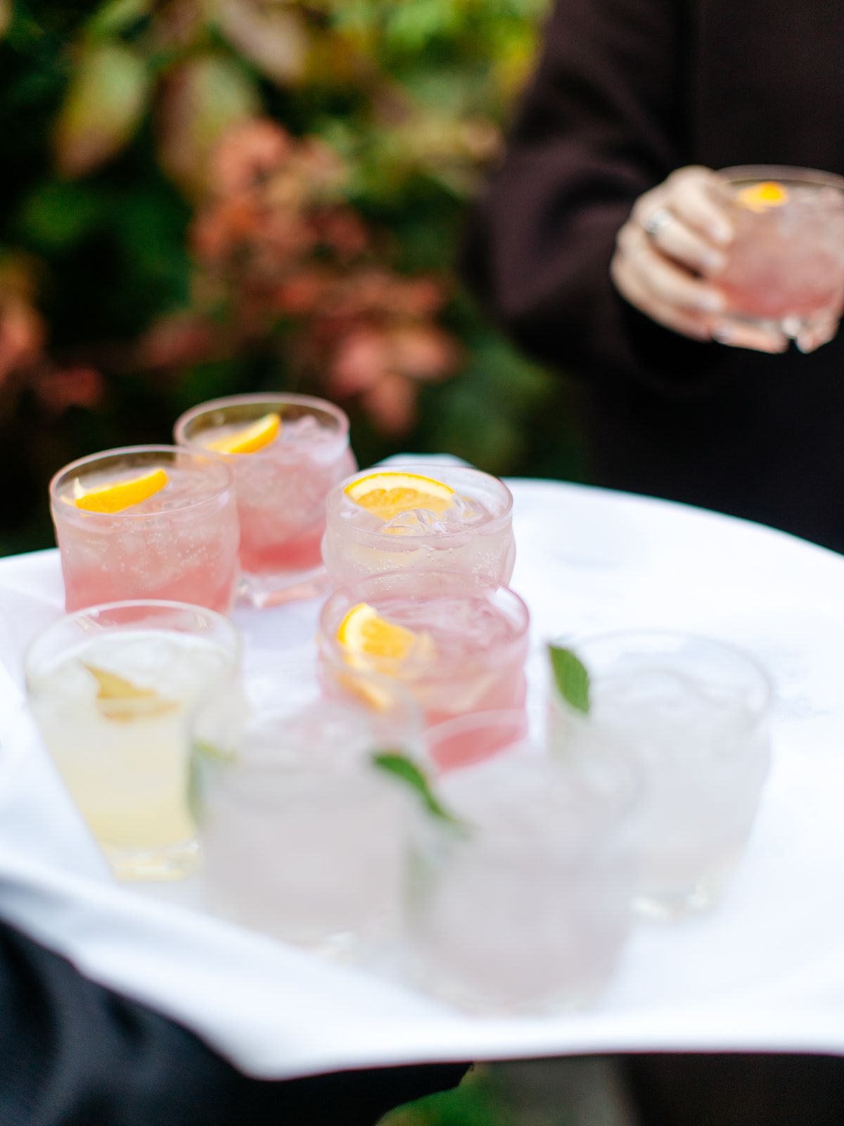 A tray of pink cocktails with lemon slices served at a Twelve Ponds wedding.